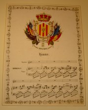 Escudo de Malinas  y partitura musical de un himno